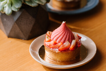 Sweet strawberry cupcake on the wooden table