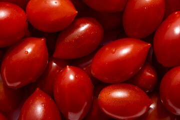 Texture of delicious red tomatoes in basket at the summer market place. Organic vegetables. Selective focus