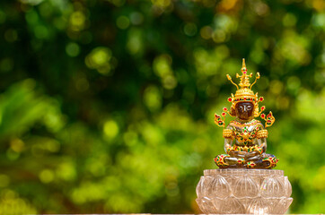 Brown stone Buddha statue made golden cover with shape, jade stone Buddha statue with warm light.