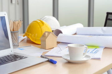 Hard safety helmet hat, construction equipment, blueprint on table in office worker conference site, architect working desk. Engineering tools concept