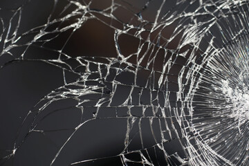 Crack on the glass. Broken screen. Broken phone. Cracked glass background. White cracks in the glass.