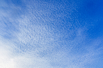 Fluffy white clouds flying on blue sky background