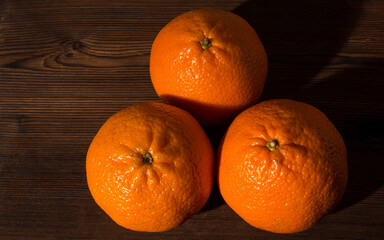 Fototapeta na wymiar Tangerines on an old natural wooden table,top view close-up,space for text