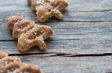Christmas homemade gingerbread cookies with cinnamon, sesame and anise on old wooden background with space for text.
