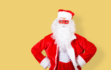 smiling and relaxed Santa Claus with modern red glasses looking to the copy space