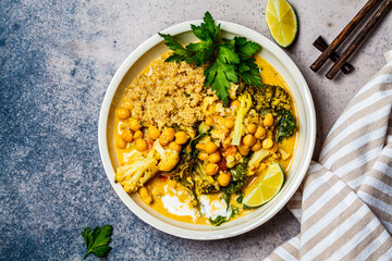 Vegan chickpea curry with cauliflower, broccoli, kale and quinoa, top view. Healthy vegetarian food concept.