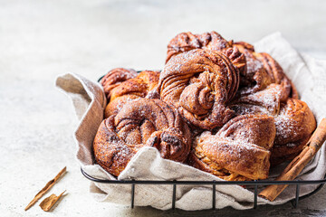Traditional Swedish buns with cardamom and cinnamon, light background. Scandinavian cuisine concept.