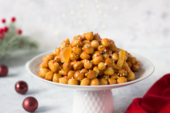Homemade struffoli. Typical Neapolitan dessert of the Christmas holidays with honey and sprinkles