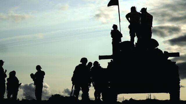 Armoured personnel carrier and a group of soldiers.