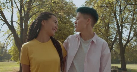 Sweet multiethnic lesbian couple flirting on date, talking and smiling, romance - Powered by Adobe