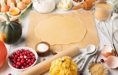 Ingredients for autumn winter baking - flour, sugar, eggs, apples, pumpkins and spices.