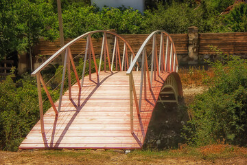 Wooden footbridge with metal railing across the ravine