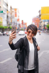 Fototapeta premium asian travel girl happy selfie with her mobile phone