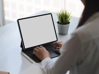 Female working with digital tablet include clipping path in co working space