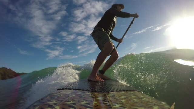 SUP surfing waves, early morning at Waihi beach, New Zealand