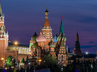 Fototapeta na wymiar Evening photo of St. Basil's Cathedral in Moscow. World landmark against the backdrop of a dark blue sunset sky. Illumination of buildings