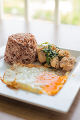 stir fried sweet basil with belly  pork and fried egg on rice