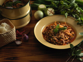 Thai traditional food, spicy minced pork salad (Larb Moo) served with vegetables and sticky rice