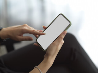 Cropped shot of female hand using smartphone include clipping path