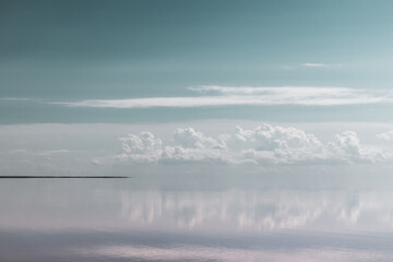 Salt lake water surface with mirror reflection of clouds color graded in pastel colors. Syvash or Sivash, the Putrid Sea or Rotten Sea, Ukraine