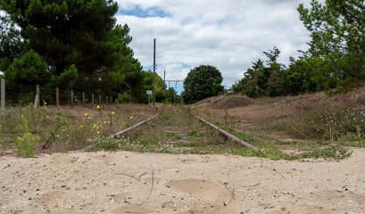 Abandoned railroad track with sand