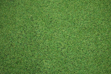 Background from green artificial grass in a sports stadium.