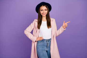 Portrait of positive cheerful girl in pastel coat point index finger copyspace recommend suggest...