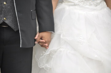 bride and groom holding hands