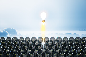 Fototapeta premium Flying lamp rocket on blue sky background.
