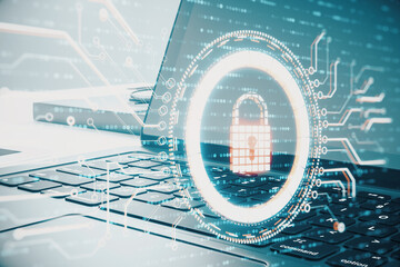 Laptop with glowing digital padlock hologram.