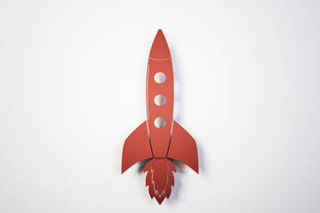 Toy red rocket on white background.