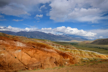 Natural attraction of Altai mountains, Martian landscapes. Stunning panorama with a ridge of rocks against a blue sky with white clouds. Popular tourist routes in Russia.