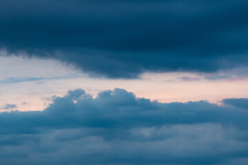 clouds with black clouds at sunset as background