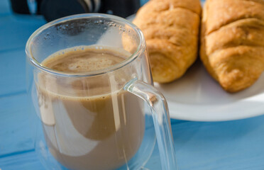 still life of cake with cup of coffee highlighted by sunlight