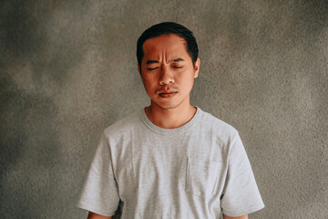 Portrait of man feeling depressed, confuse, frowned, dizzy expression concept.