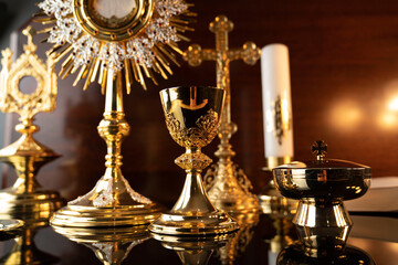 Fototapeta na wymiar Catholic religion concept. Catholic symbols composition: The Cross, monstrance and golden chalice.