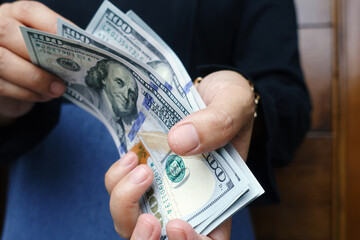Close-up female Hands counting money American dollars , Counting money American dollars with hand ,...