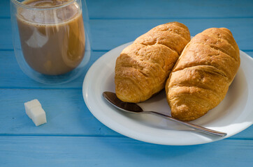 still life of cake with cup of coffee highlighted by sunlight