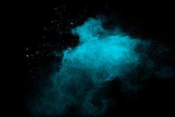 Green color powder explosion cloud on black background.Green dust splash.