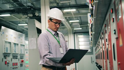 Male specialist is inspecting an electricity facility