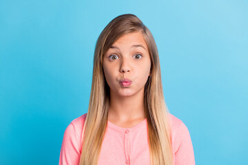 Photo portrait of pouting schoolgirl isolated on pastel blue colored background