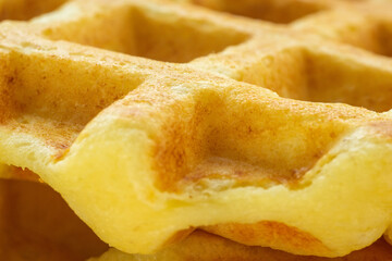 waffles Belgian, fluffy or egg waffles. Close-up traditional European dessert. food background macro textured surface.