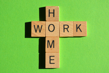 Home, Work, words in wooden alphabet letters in crossword form isolated on green background
