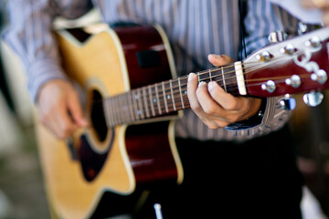 Close-Up Of Person Playing Guitar
