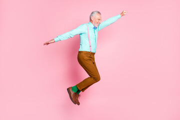 Full length body size side profile photo of funny granddaddy jumping high pretending superhero...