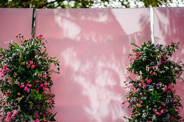 Wedding decorations in luxury ceremony. Arch decorated with flowers and greens, greenery. wedding decor in the backyard banquet area.