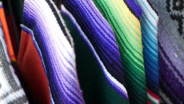 Colorful mexican wool serape blankets texture. Woven ornamental vivid textile with authentic latin american pattern. Striped multi colored fabric for poncho and sombrero. Hispanic indigenous style.