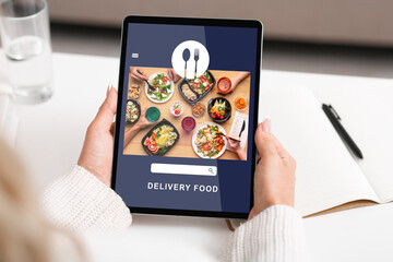 Food delivery to office or home during covid-19 outbreak. Woman use tablet