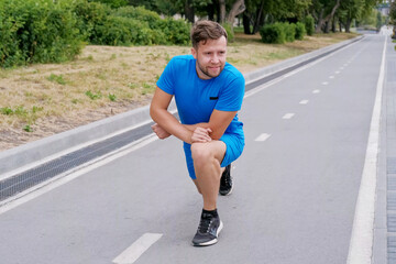 Man stretches his muscles and ligaments, does yoga, and trains before running.