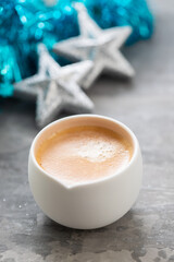 one cup of coffee with Christmas decoration on ceramic background